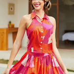 Woman wearing a colorful summer outfit with a blurred indoor background