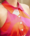 Close-up of collared halter neckline with button-front detail in abstract print