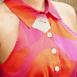 Close-up of collared halter neckline with button-front detail in abstract print