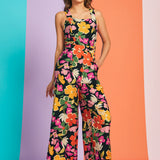 Woman wearing retro floral wide-leg jumpsuit with square neckline and cropped silhouette in bloom print