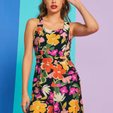 Woman posing in colorful floral jumpsuit with square neckline and relaxed fit
