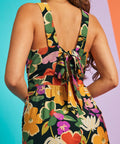 Close-up of floral jumpsuit back bow detail and textured woven fabric