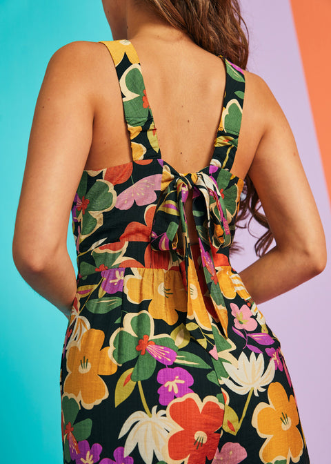 Close-up of floral jumpsuit back bow detail and textured woven fabric