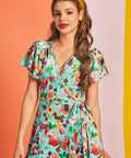 Woman wearing retro fruit print mini dress styled with mustard headband