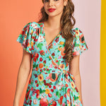 Woman wearing retro fruit print mini dress styled with mustard headband