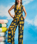 Woman wearing retro-inspired tropical palazzo pants with matching sleeveless top