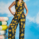Woman wearing retro-inspired tropical palazzo pants with matching sleeveless top