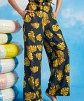 Woman posing in vintage-inspired tropical palazzo pants with pockets