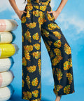 Woman wearing tropical leaf print palazzo pants with cropped wide-leg silhouette