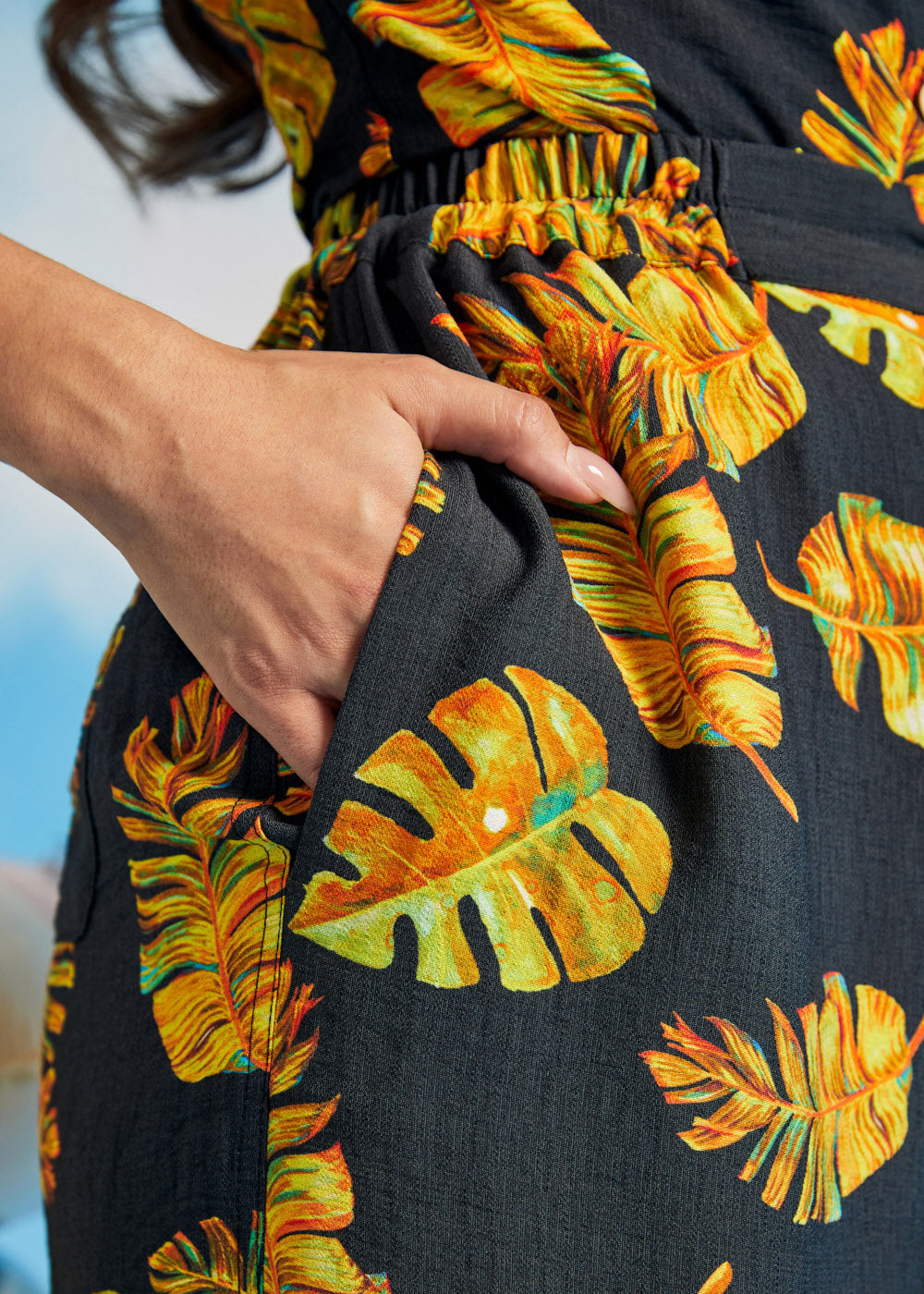 Close-up of tropical print palazzo pants with side pocket and elastic waistband