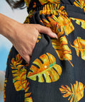 Close-up of tropical print palazzo pants with side pocket and elastic waistband