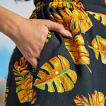 Close-up of tropical print palazzo pants with side pocket and elastic waistband