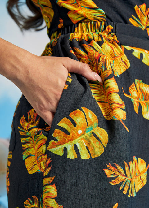 Close-up of tropical print palazzo pants with side pocket and elastic waistband