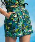 Woman wearing retro tropical print shorts with hidden leopard and parrot details