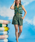 Full-length view of relaxed fit green utility shorts with oversized patch pockets