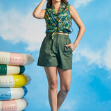 Full-length view of relaxed fit green utility shorts with oversized patch pockets