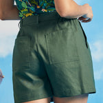 Back view of olive green utility shorts with large rear patch pockets