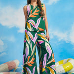 Woman wearing a colorful leaf-patterned top with matching wide leg pants