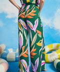 Side view of extra-wide tropical print palazzo pants with fluid drape