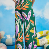 Side view of extra-wide tropical print palazzo pants with fluid drape