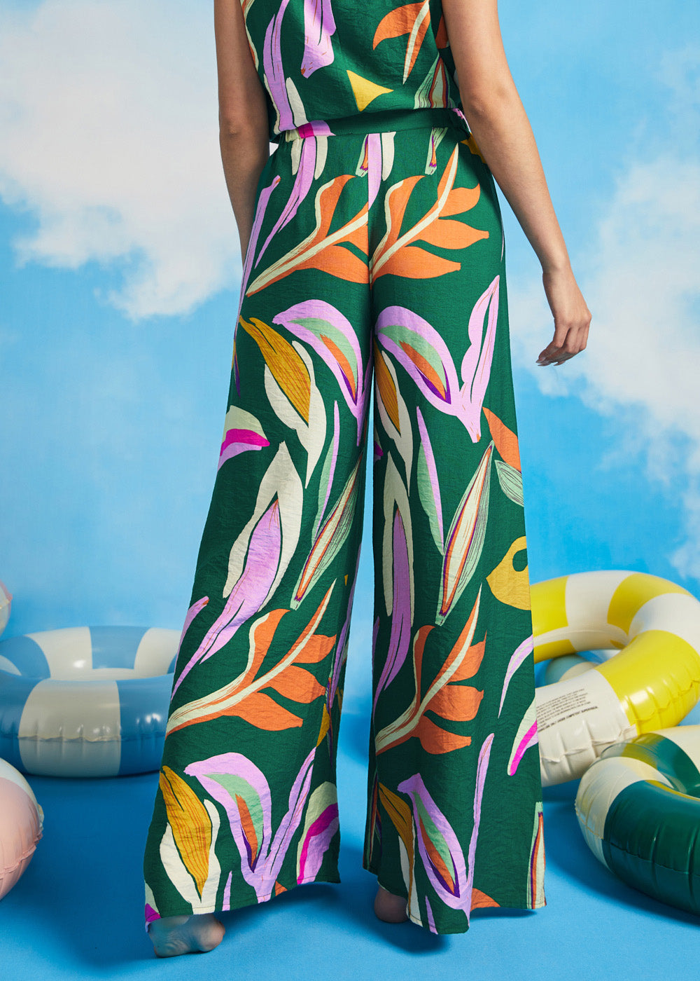 Back view of colorful abstract print palazzo pants with elastic side waist inserts