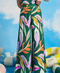 Woman wearing retro-inspired tropical print palazzo pants with wide legs