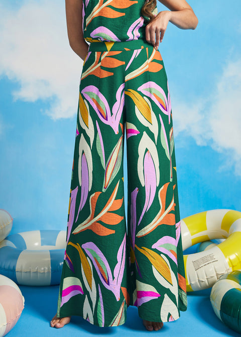 Woman wearing retro-inspired tropical print palazzo pants with wide legs