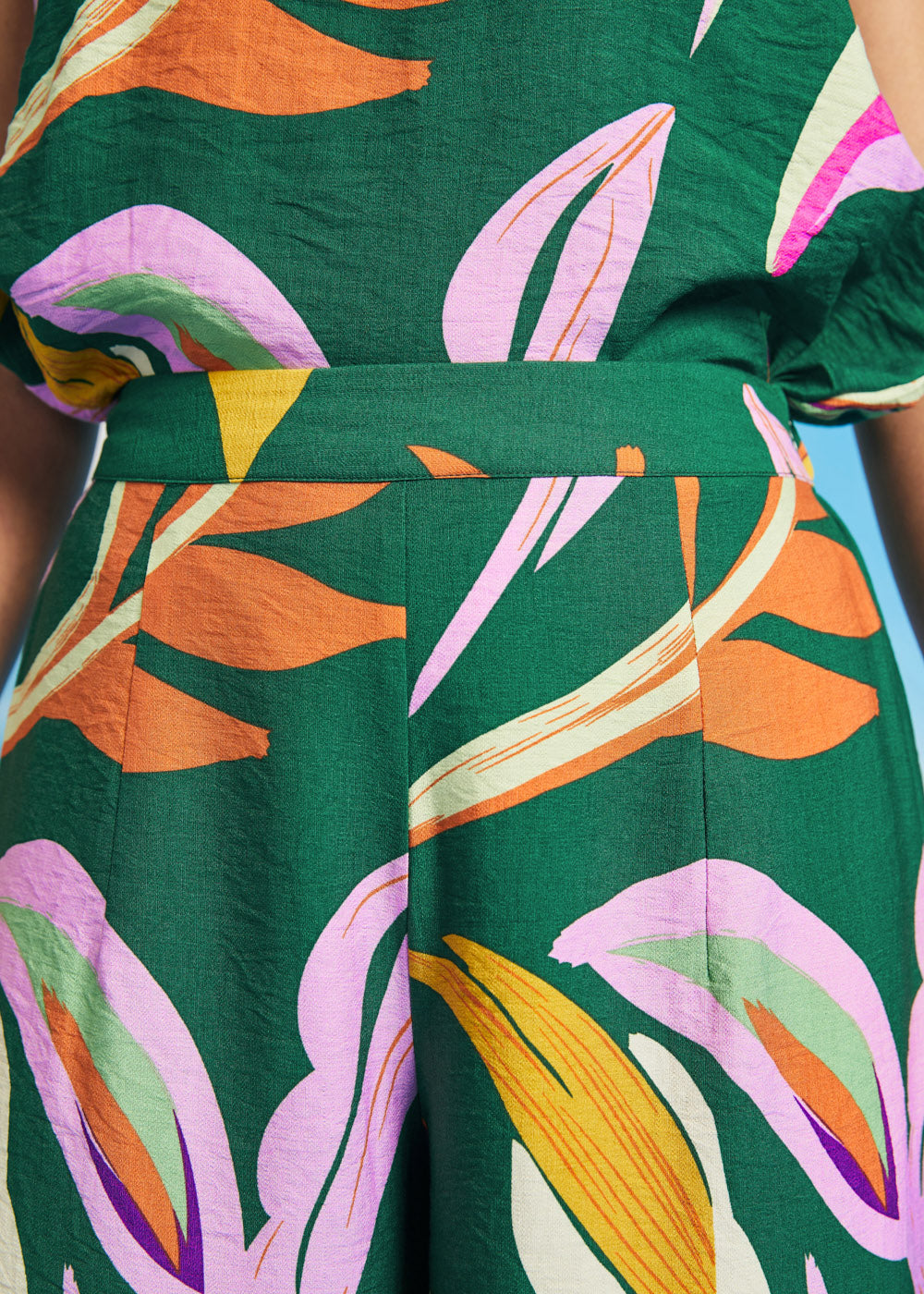 Close-up of waistband detail on tropical abstract print palazzo pants