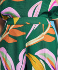 Close-up of waistband detail on tropical abstract print palazzo pants