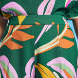 Close-up of waistband detail on tropical abstract print palazzo pants
