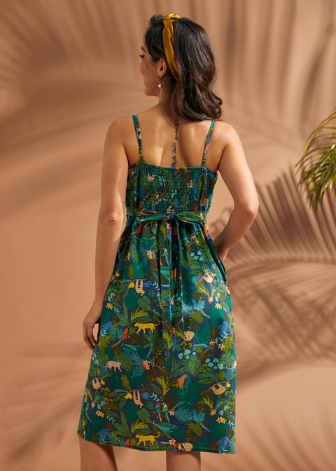 Back view of jungle print dress with smocked panel and self-tie waist sash.