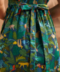 Close-up of the smocked back and tie detail on the tropical print dress.