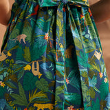 Close-up of the smocked back and tie detail on the tropical print dress.