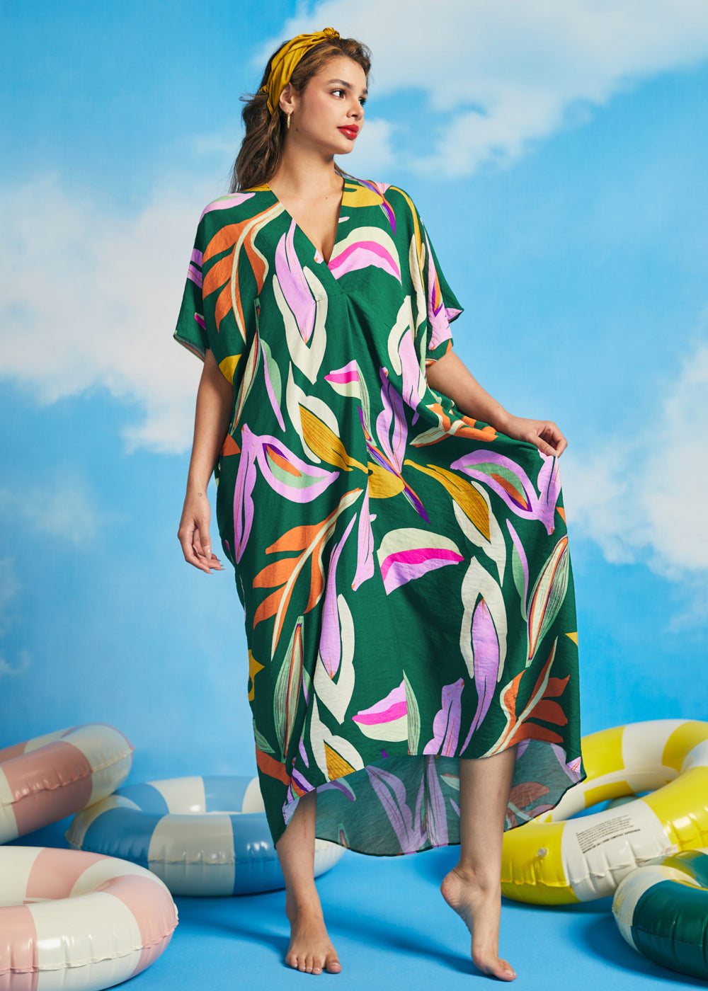 Front view of green oversized resort caftan dress with flowing silhouette and short sleeves