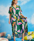 Front view of green oversized resort caftan dress with flowing silhouette and short sleeves