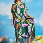 Front view of green oversized resort caftan dress with flowing silhouette and short sleeves