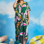 Woman wearing retro tropical caftan maxi dress with colorful abstract palm print