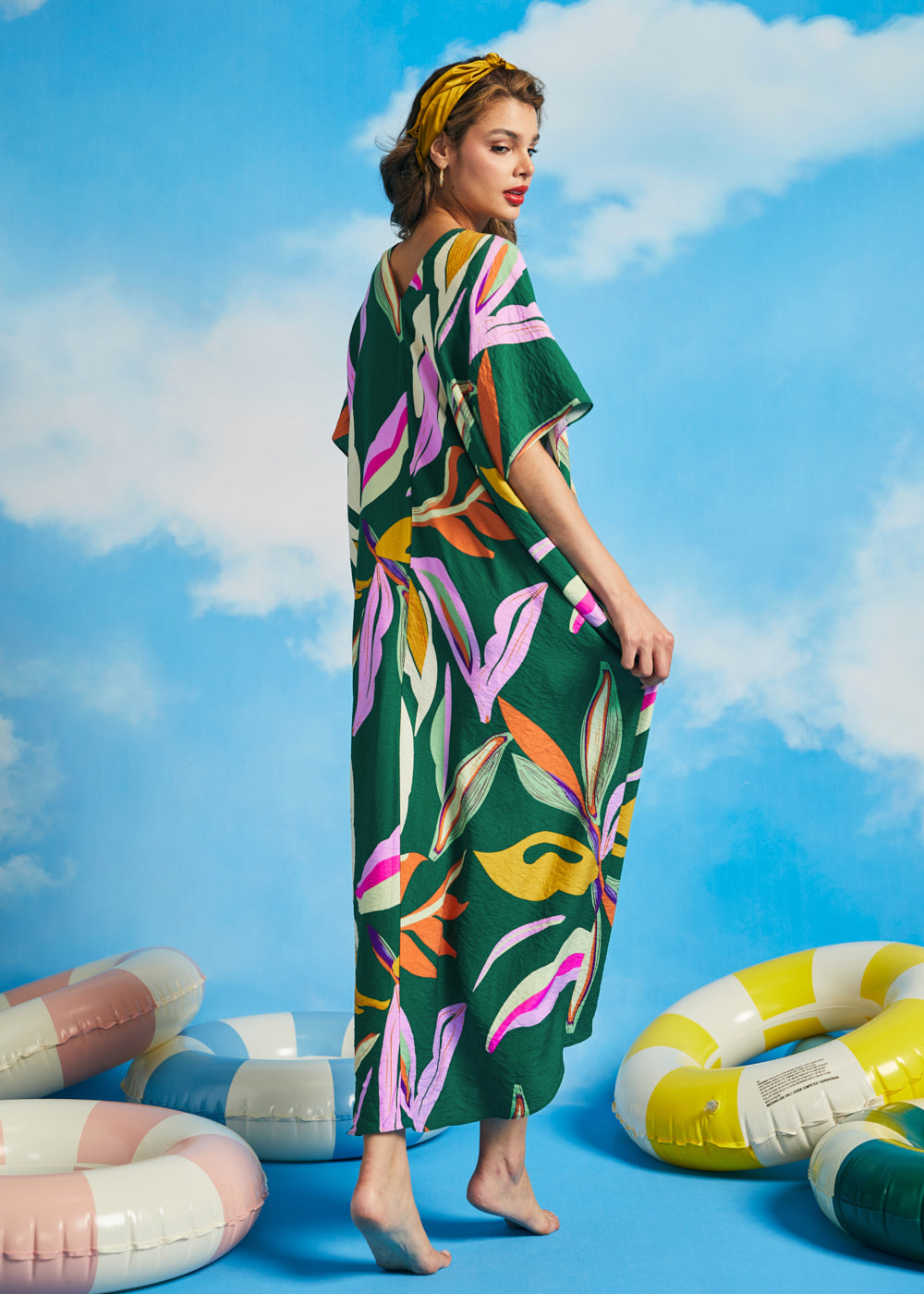Back view of relaxed green caftan maxi dress with oversized tropical leaf print