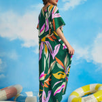Back view of relaxed green caftan maxi dress with oversized tropical leaf print