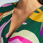 Close-up of V-neckline and textured fabric on retro botanical maxi caftan