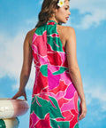 Back view of pink tropical floral mini dress with halter neckline and relaxed silhouette