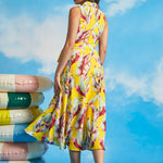 Back view of tropical yellow midi dress with sleeveless silhouette and flowing hem