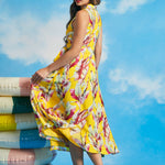 Back view of yellow tropical leaf print sleeveless midi dress with flowing skirt