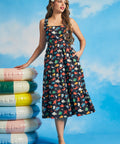 Woman wearing vintage-inspired ocean print midi dress with square neckline and tiered silhouette