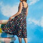 Side view of navy cotton fit-and-flare dress with tiered skirt and whimsical fish print
