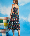 Back view of navy tiered midi dress with smocked back panel and colorful sea life print