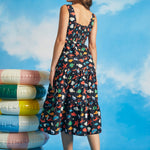 Back view of navy tiered midi dress with smocked back panel and colorful sea life print