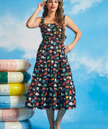 Woman wearing sleeveless square neck midi dress with underwater novelty print and pockets