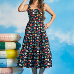 Woman wearing sleeveless square neck midi dress with underwater novelty print and pockets