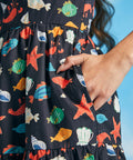 Close-up of side pocket on navy seaside novelty print fit-and-flare dress